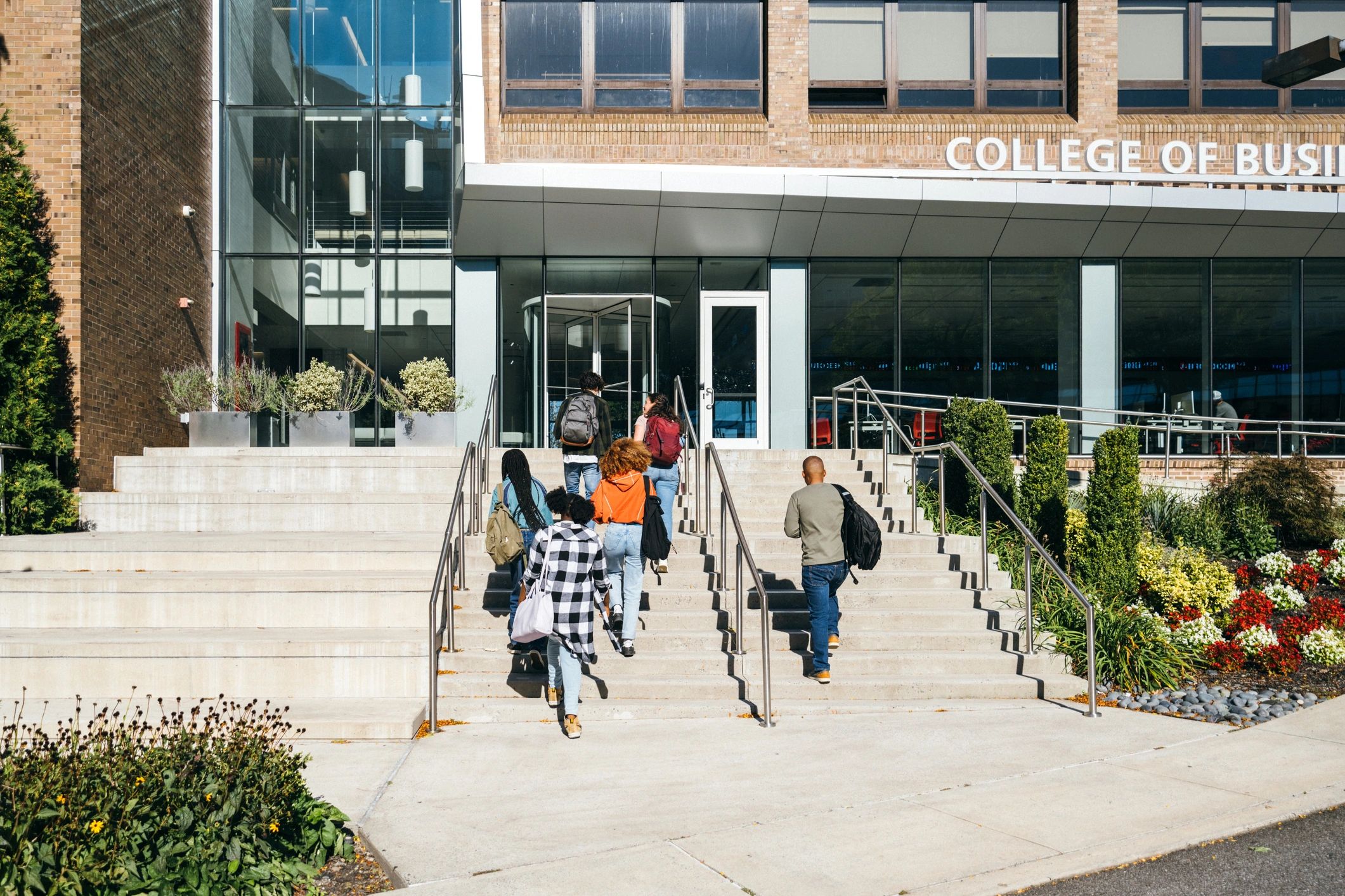Students walking up stairs at a business college