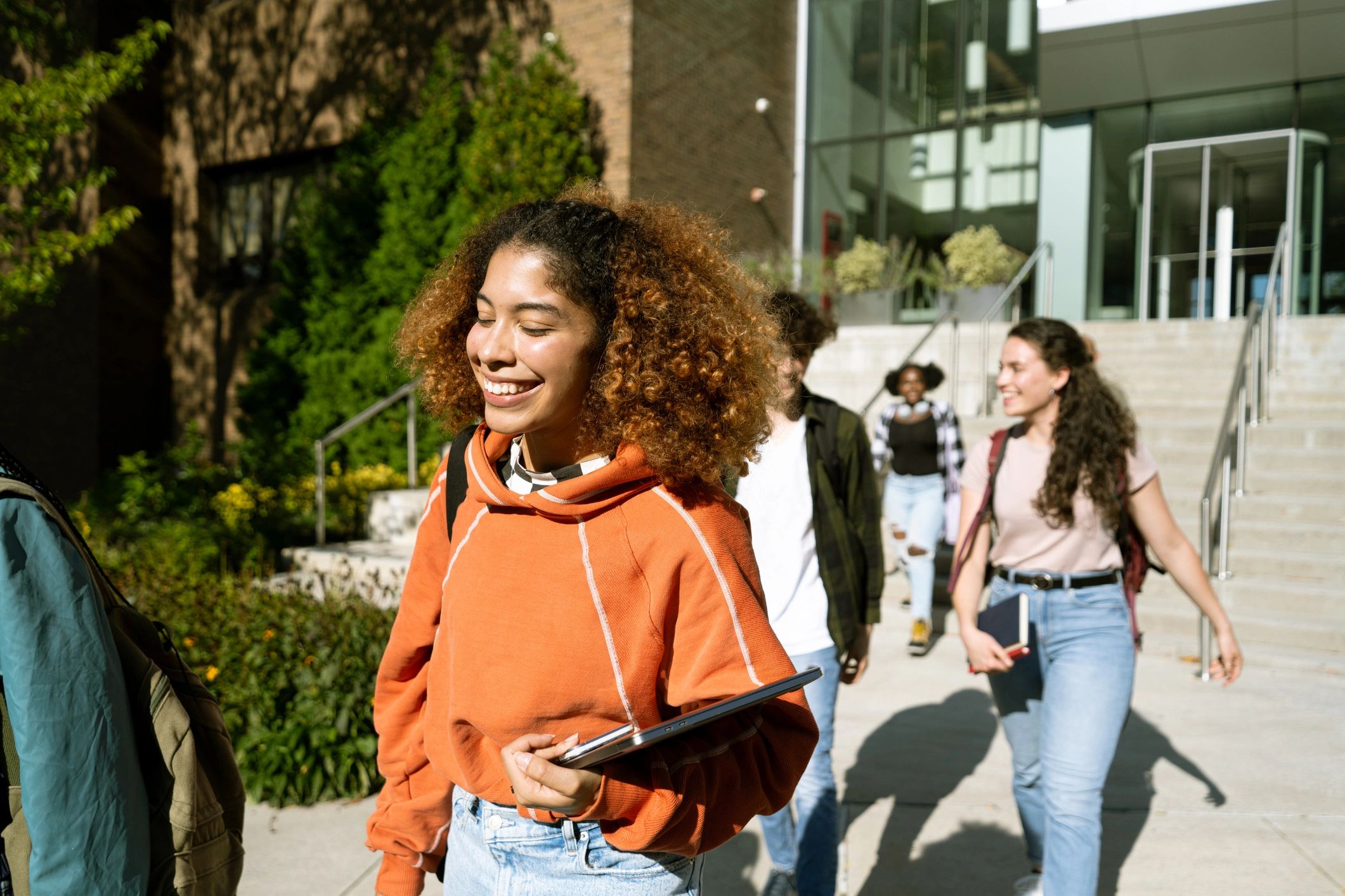 Students leaving a university building with backpacks